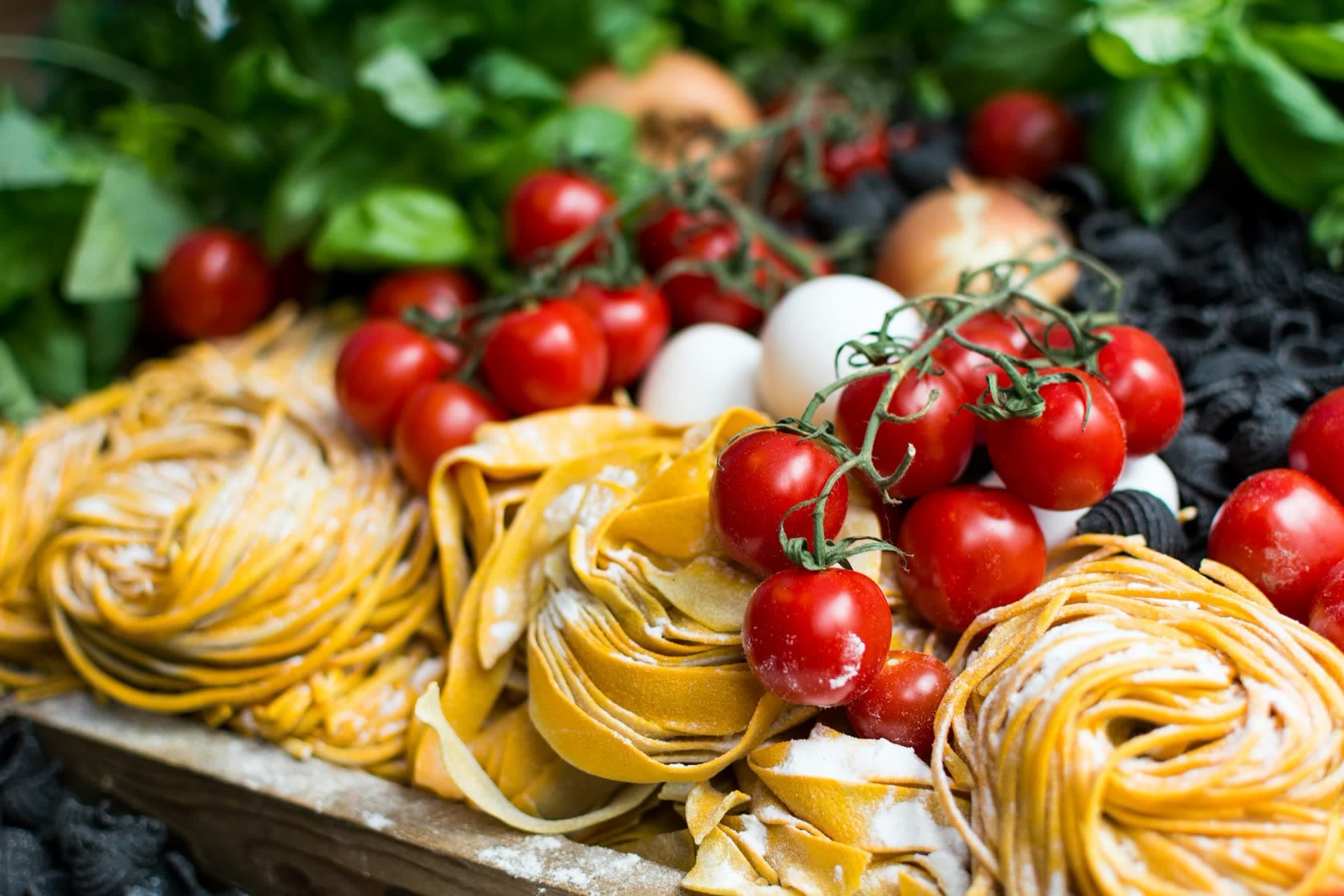 Fresh handmade pasta with vine tomatoes and basil