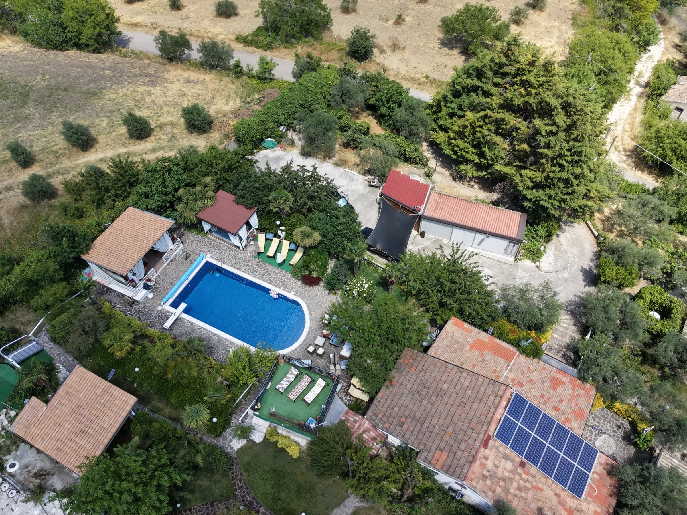 Aerial view of the guest accommodation with pool, gardens and the surrounding countryside